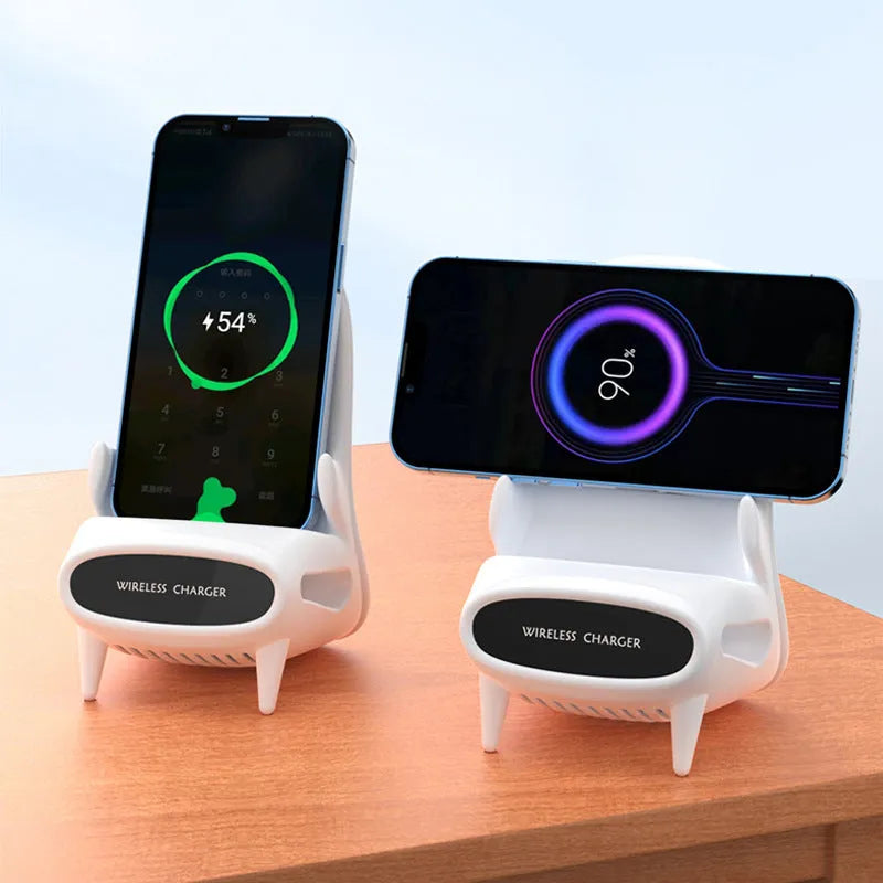 White mini chair-shaped wireless phone charger on a desk, with phone seated on it.