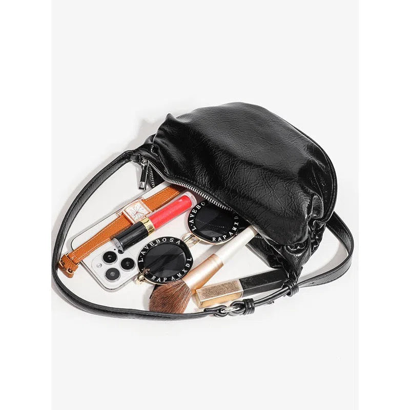 Black pleated shoulder bag in soft PU with rock-and-roll style and three-dimensional outer pocket