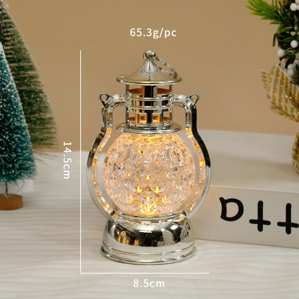 Small retro-style oil lamp LED night light in gold or silver finish on a table.
