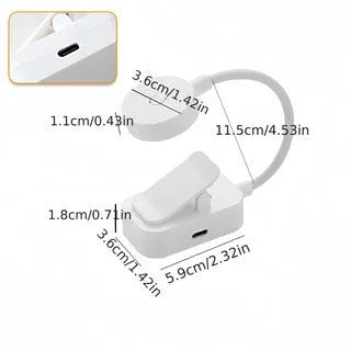 Portable rechargeable clip light in modern simplicity style clipped onto a desk for reading