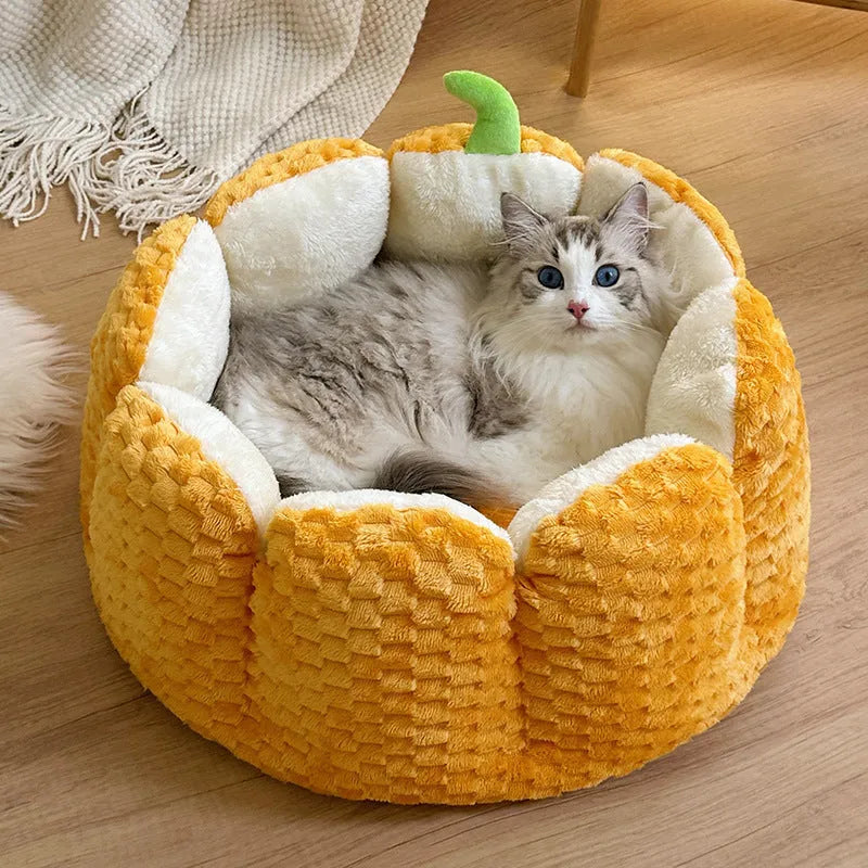 Pumpkin-shaped orange cat nest with raised sides and cotton filling in two size options