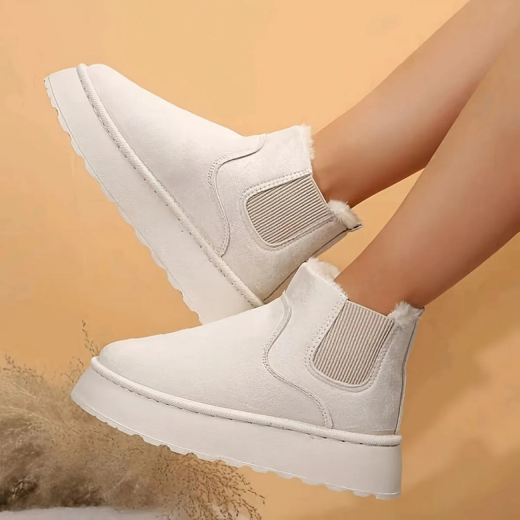 Women's winter snow boots in round toe style with thick rubber sole, cotton fabric upper, and velvet inner lining