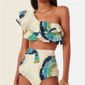 White women's one-shoulder bikini with large lotus leaf detail and split-leg design.