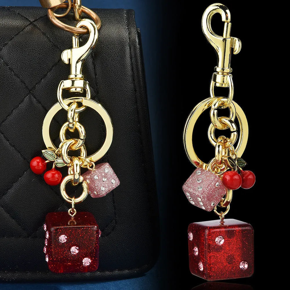 Square cherry red and silver dice pattern metal keychain pendant on a key ring