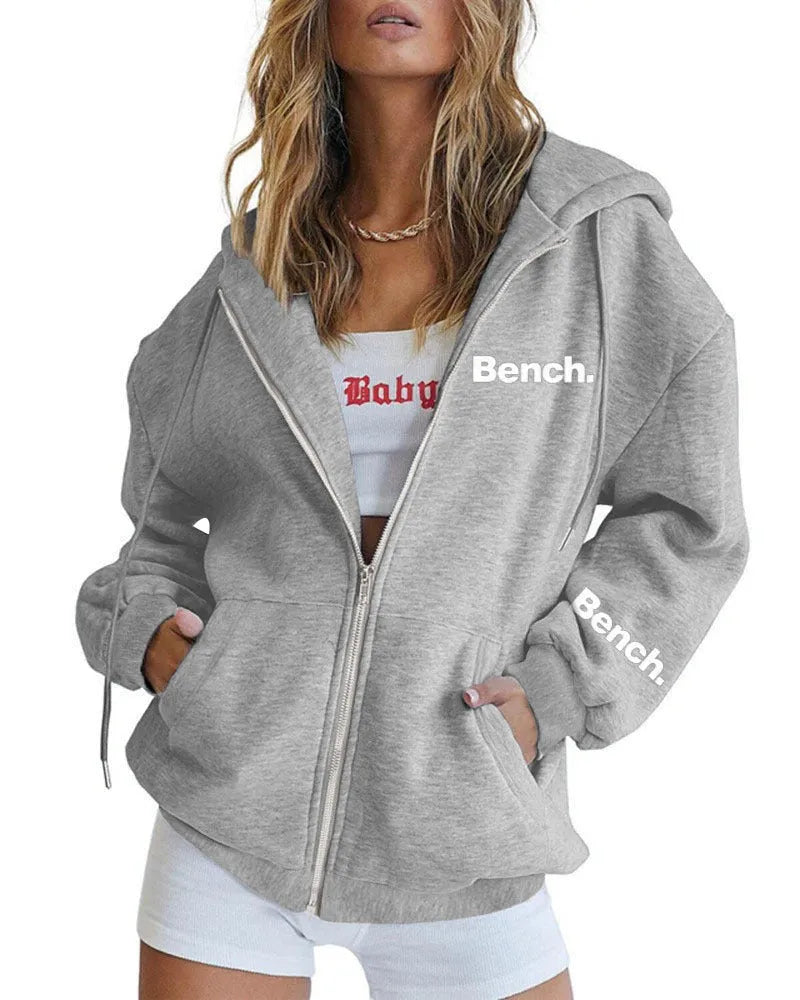 A black loose-fit zipper hooded sweater coat on a hanger, showing the full front zipper and hood.