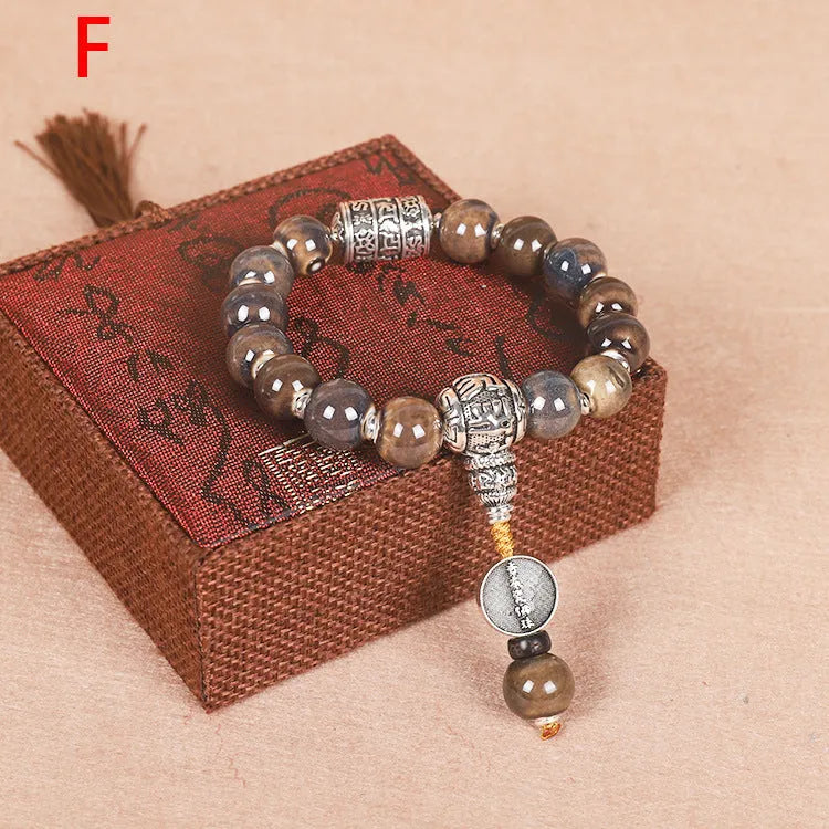 Men's gradient ceramic Yonghe blessing bracelet with coloured glaze beads on a wrist.