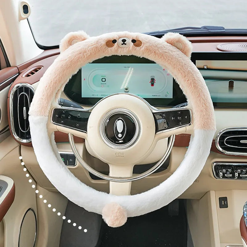 Plush rabbit fur style steering wheel cover with embroidered panda design, fitted on a car wheel