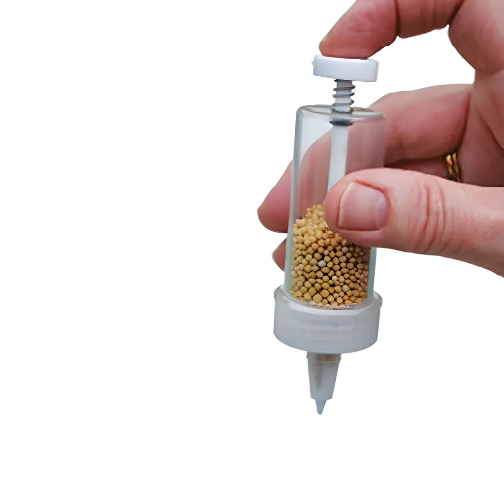 Plastic mini garden seeder tool measuring 12cm long for precise seed planting in pots