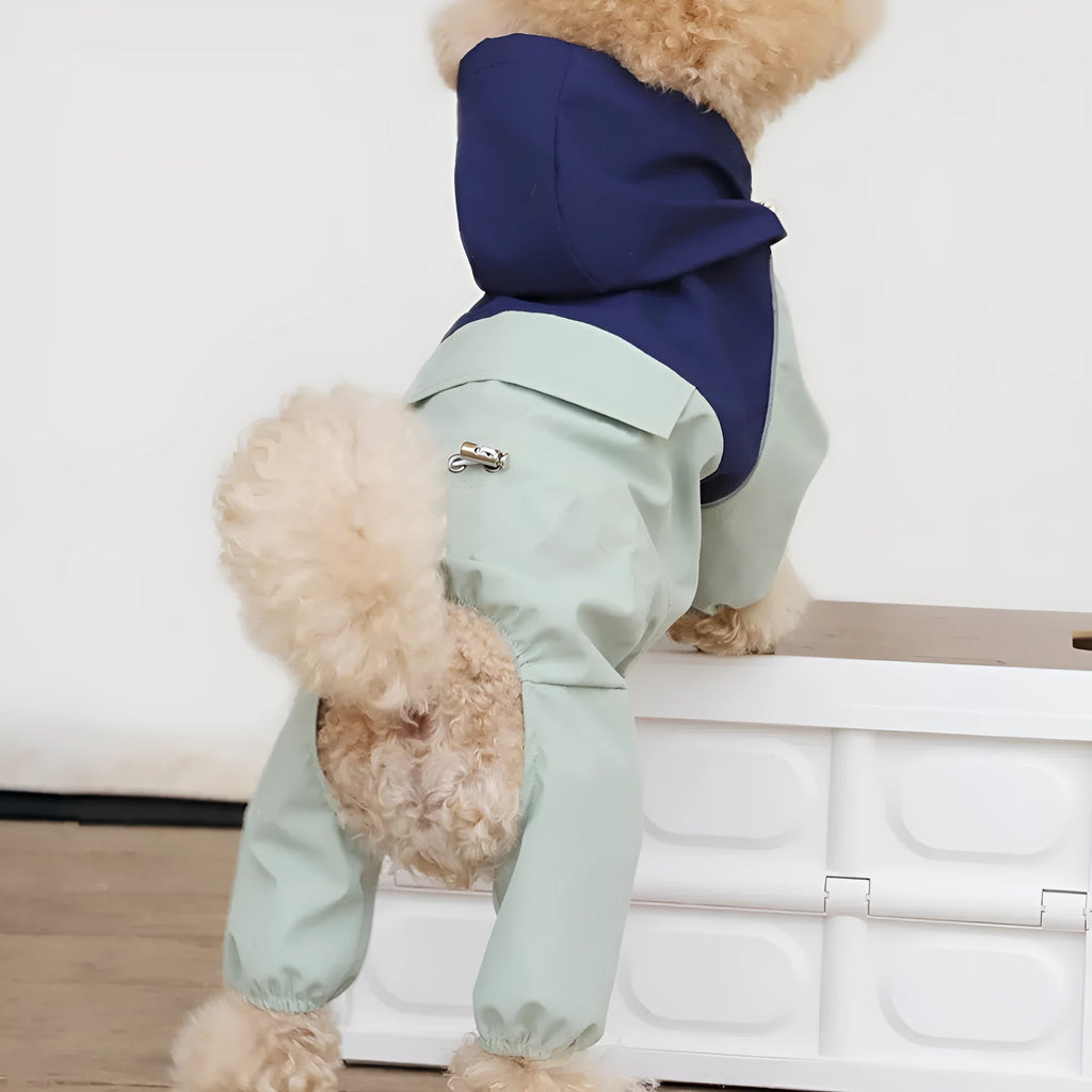 Khaki coloured waterproof shell jacket for a small dog, fastened with three white plastic snaps on the chest.