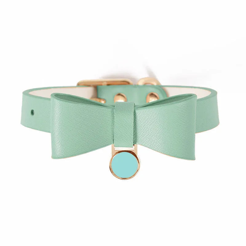 Brown leather cat collar with metal buckle adjustment on a grey background