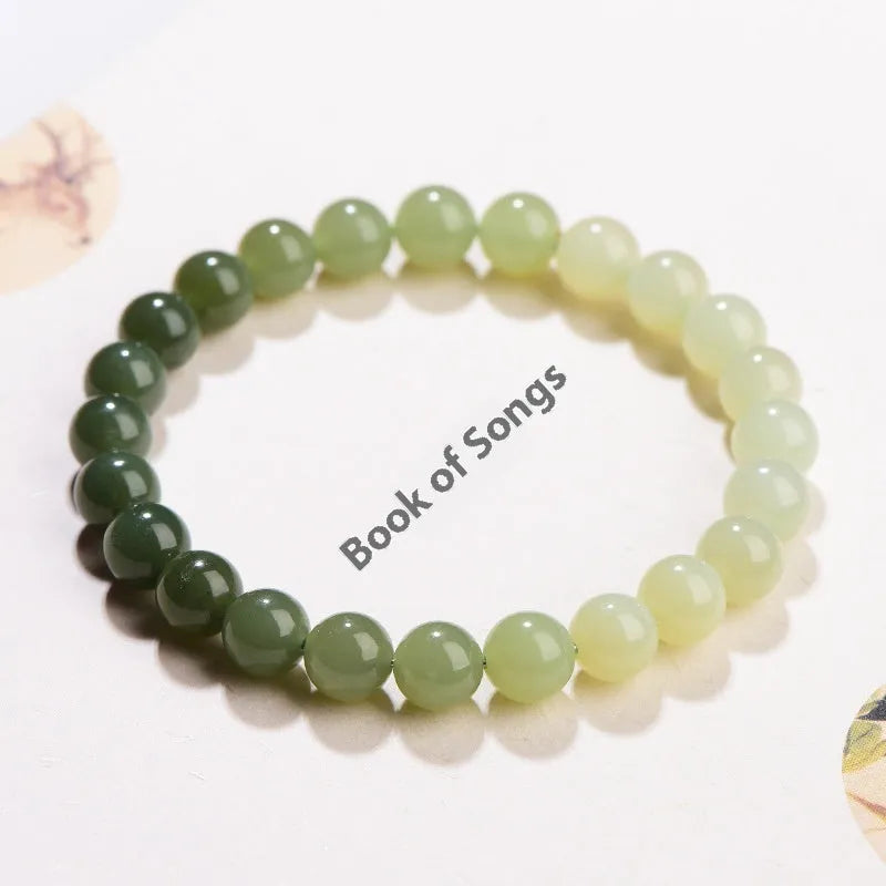 Natural clear water Hetian jade ball bracelet with round beads on a wrist.