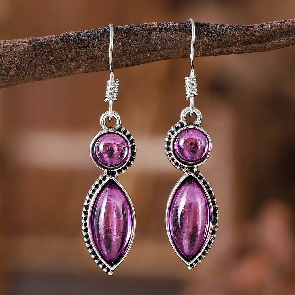 A pair of vintage-style geometric pendant earrings with purple and black stones on a zinc alloy frame.