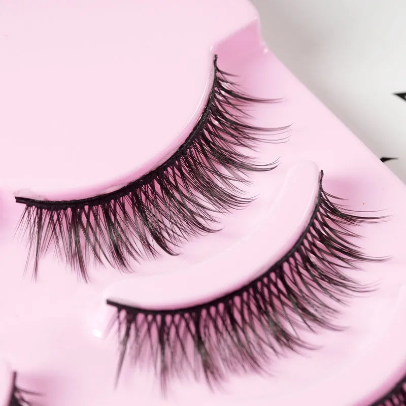 Five pairs of natural wispy manga false eyelashes in a tray, anime cosplay makeup style