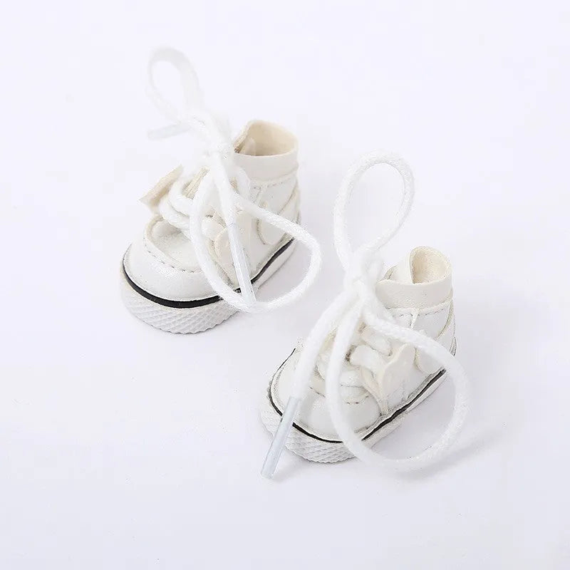A pair of 17 cm high black doll shoes made from PU leather, shown as a keychain accessory.