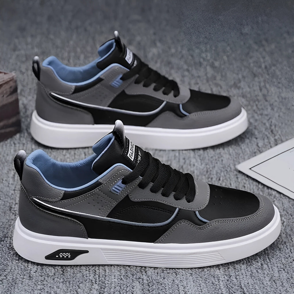 Men's low-top casual canvas shoes in beige with leather stitching detail on a white background.