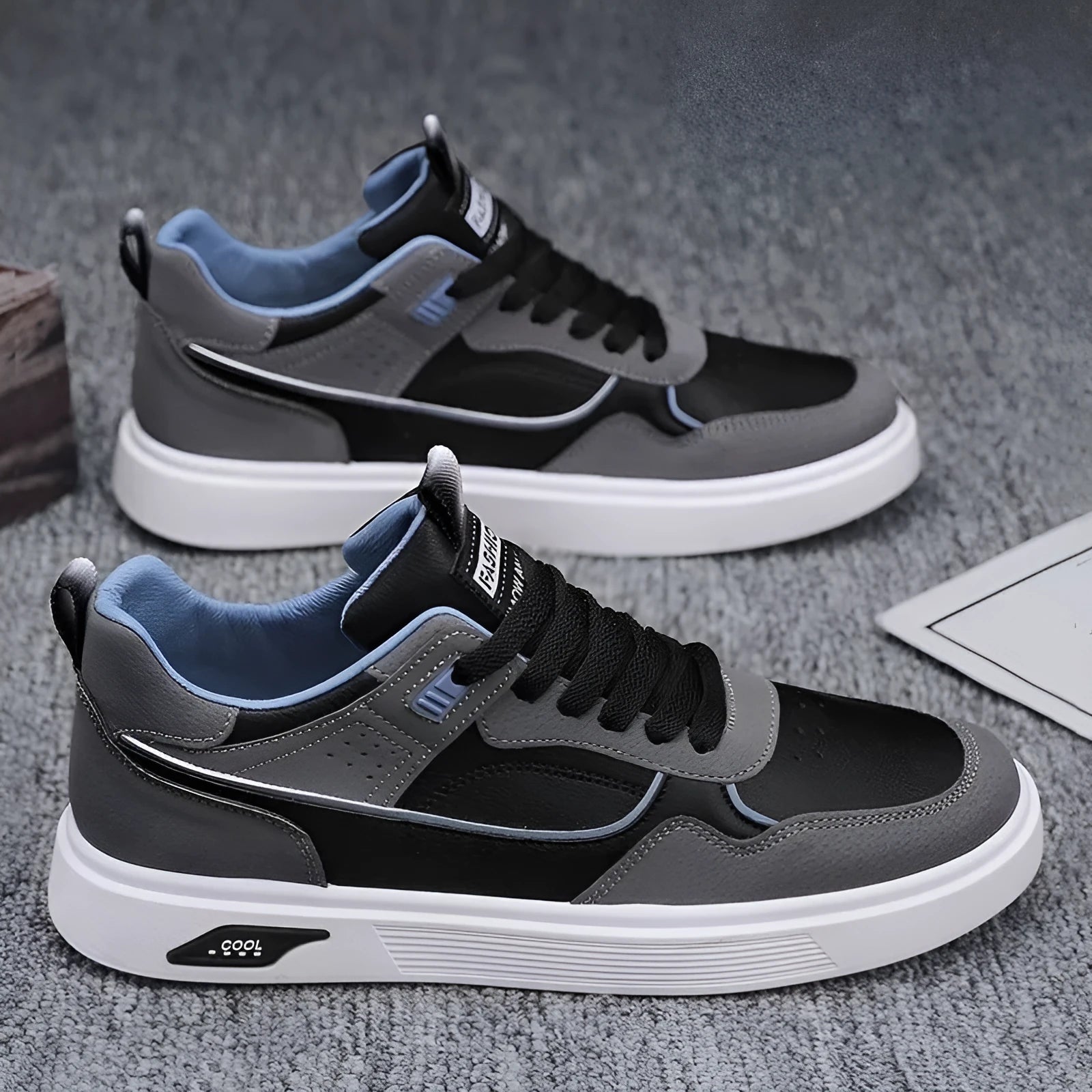 Men's low-top casual canvas shoes in beige with leather stitching detail on a white background.
