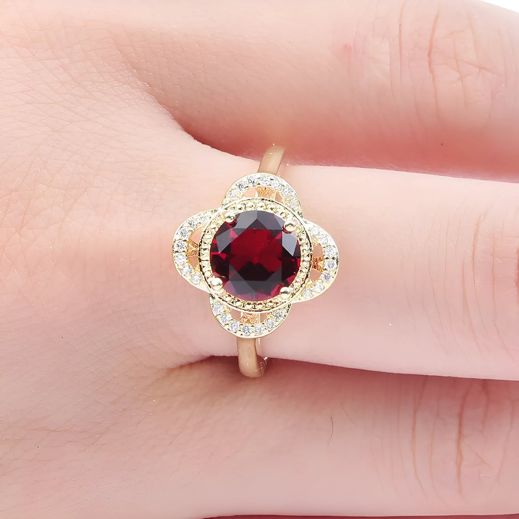 Copper ring with a fruit-shaped setting holding a zircon stone.