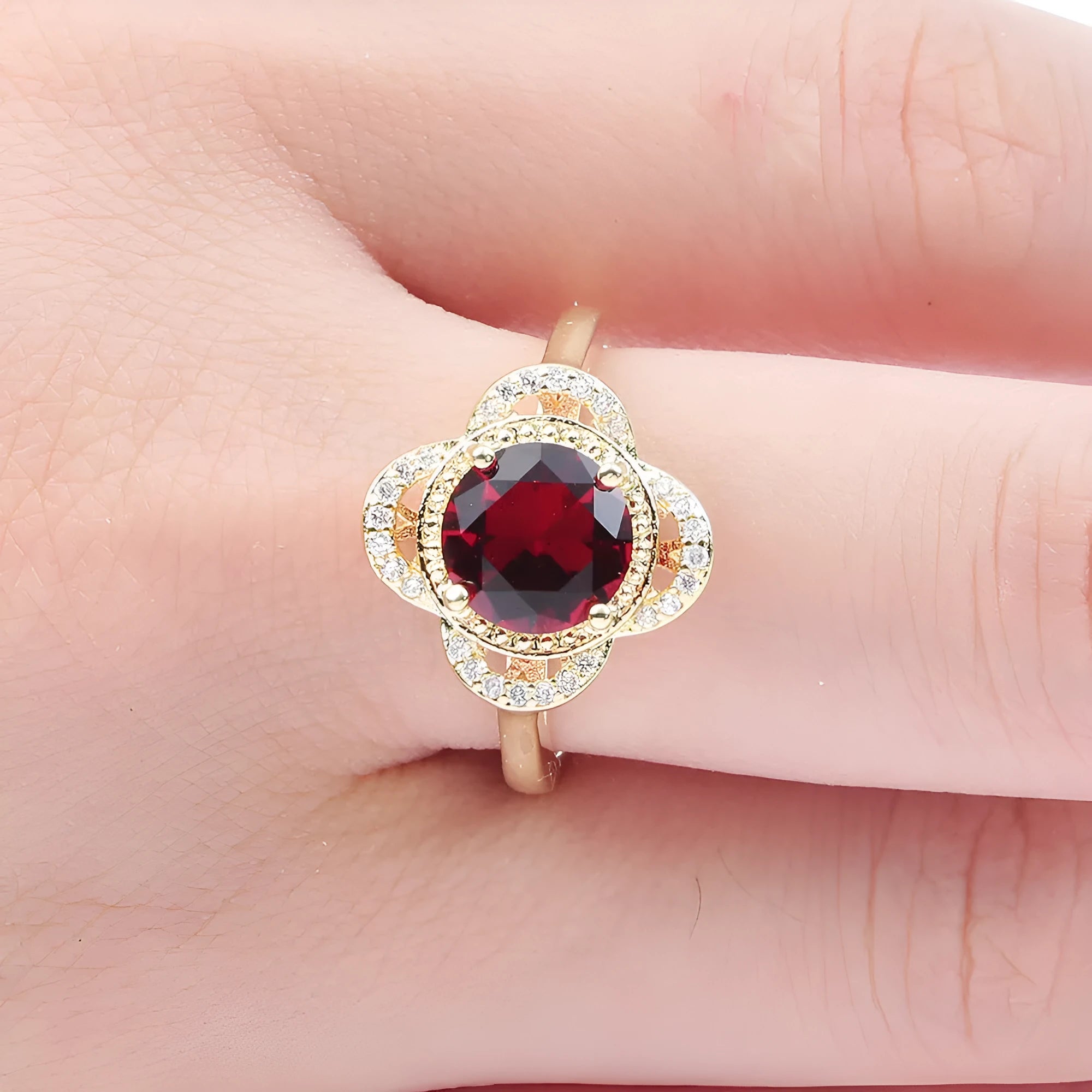 Copper ring with a fruit-shaped setting holding a zircon stone.