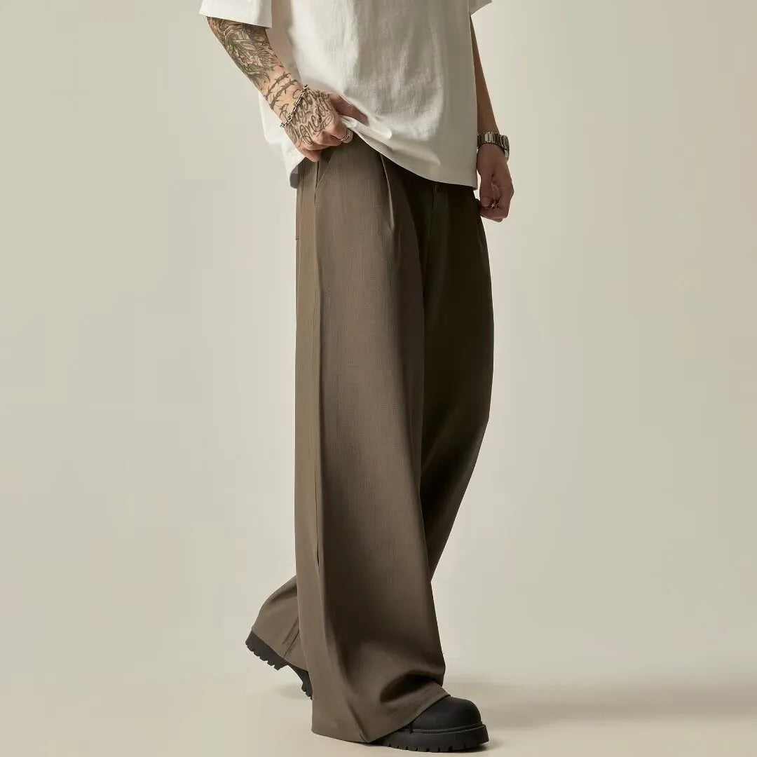 Men's solid colour cotton blend wide-leg casual trousers on a hanger, showing the straight-leg cut and button fly.