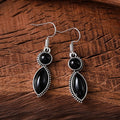 A pair of vintage-style geometric pendant earrings with purple and black stones on a zinc alloy frame.