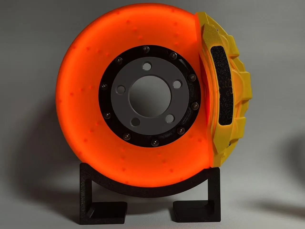 Brake disc design rechargeable LED night light with touch control in blue, red or yellow.