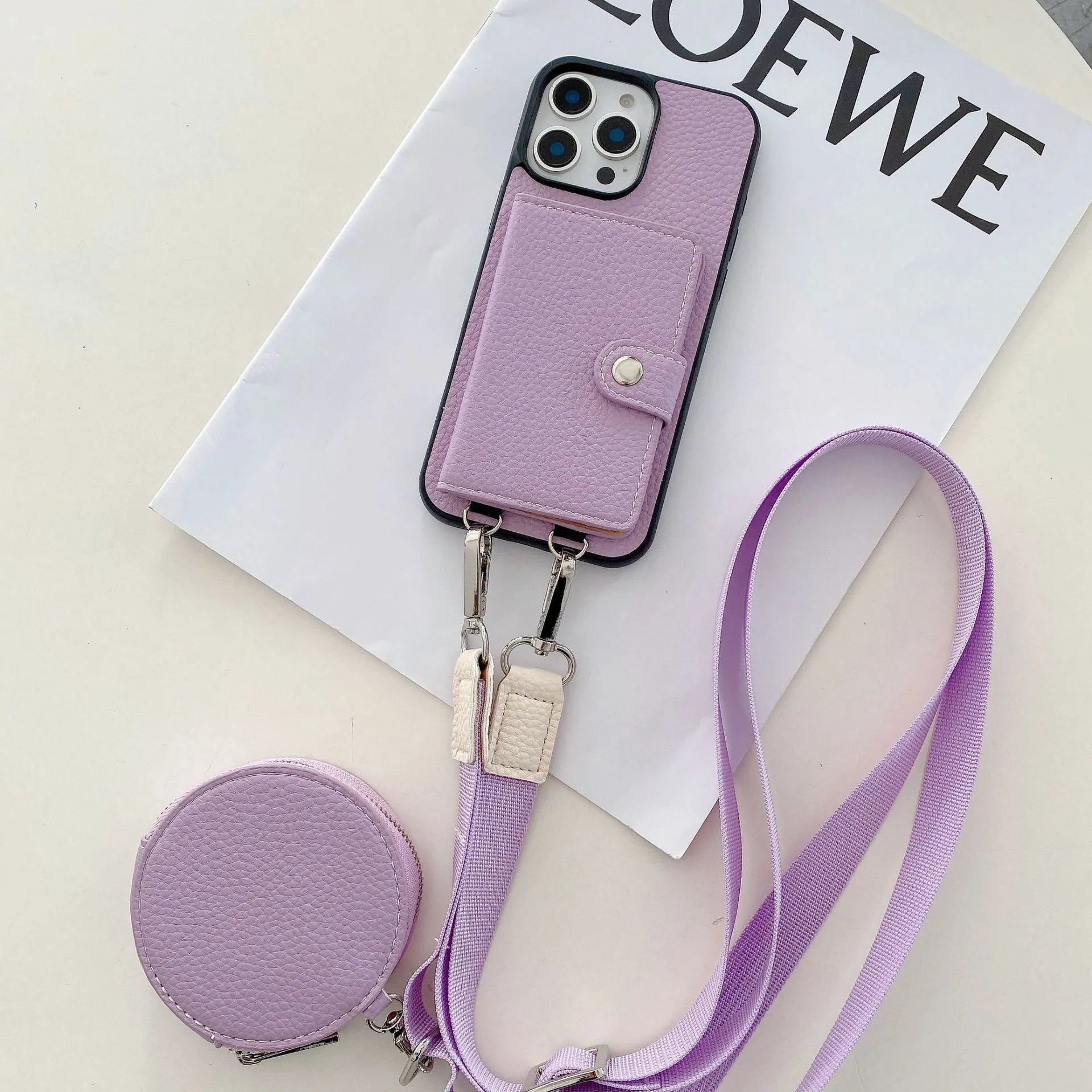 Polycarbonate leather lanyard phone case with card slot for iPhone, shown in black, brown, orange and white.