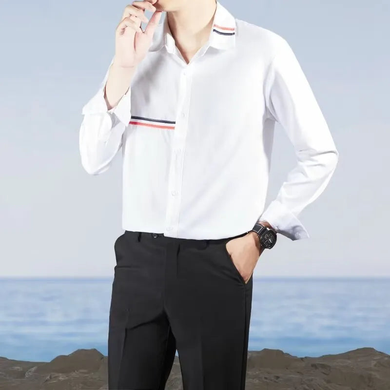 Man wearing a loose fit Hong Kong style casual shirt in a light blue cotton blend fabric.