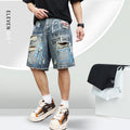 Blue men's ripped denim shorts with graffiti style and straight leg cut on a hanger.