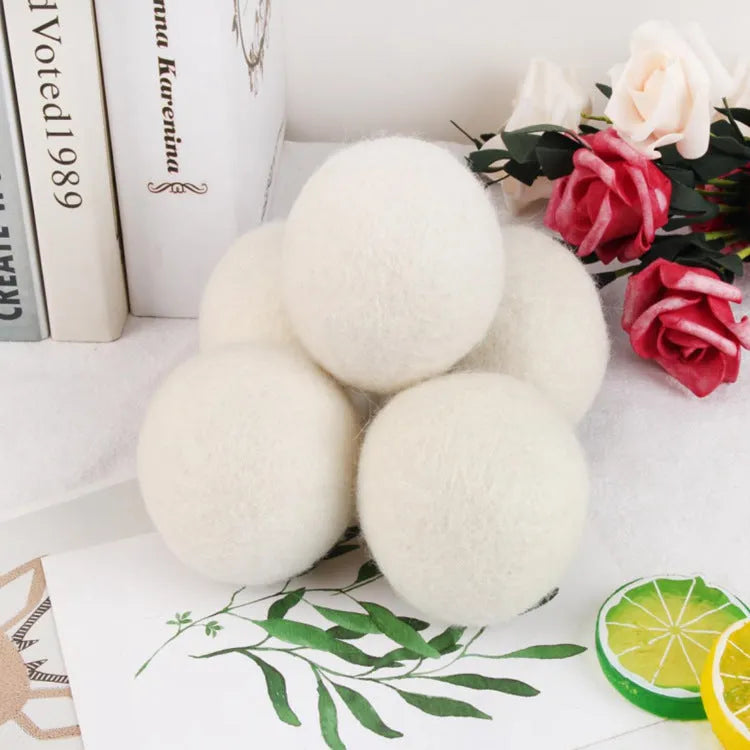 Wool laundry drying ball in various sizes with cotton storage bag for tumble dryer use