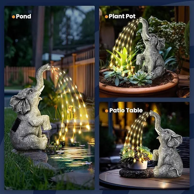 Grey resin elephant garden statue with warm white LED light glowing at its base on a patio.