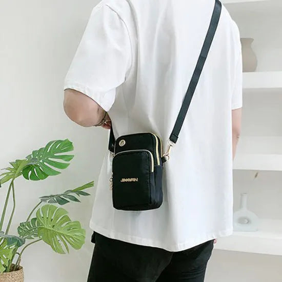 Nylon crossbody mobile phone bag with three zippered layers, card slots, and an adjustable strap in black