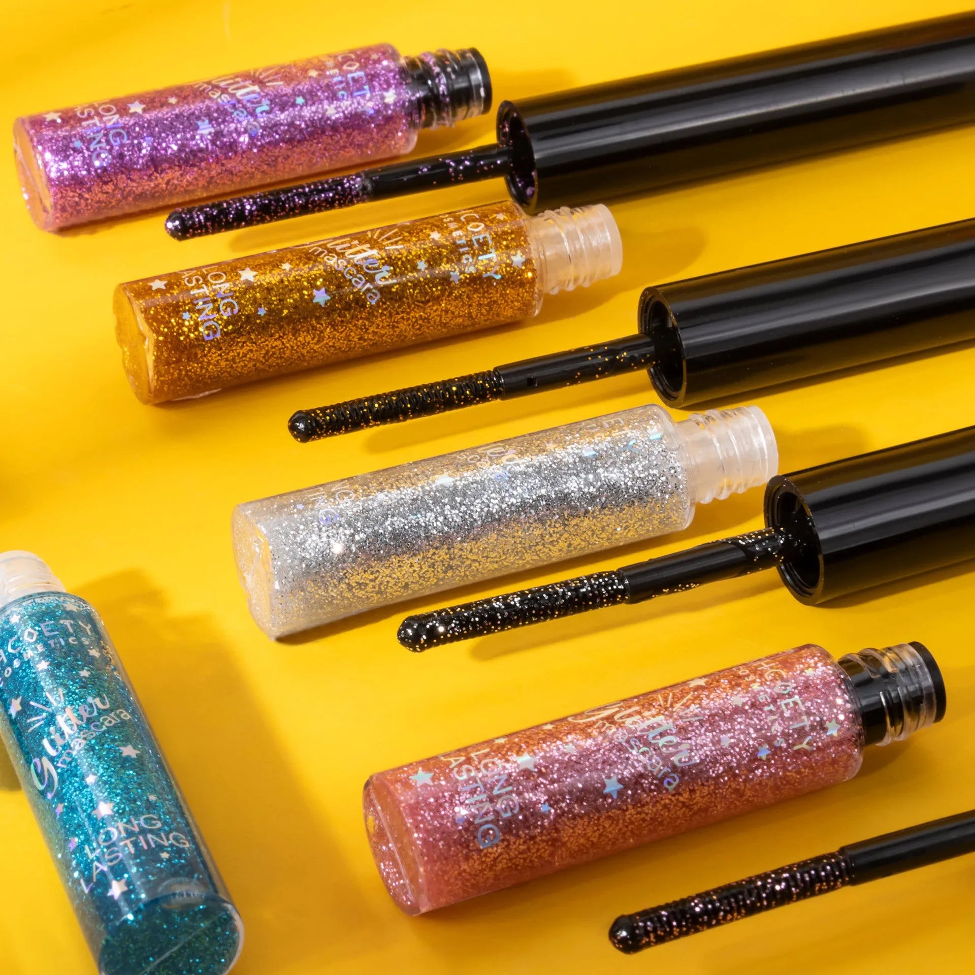 Waterproof colour mascara in five shades including pink, gold, purple, blue, and iron grey with non-smudge formula