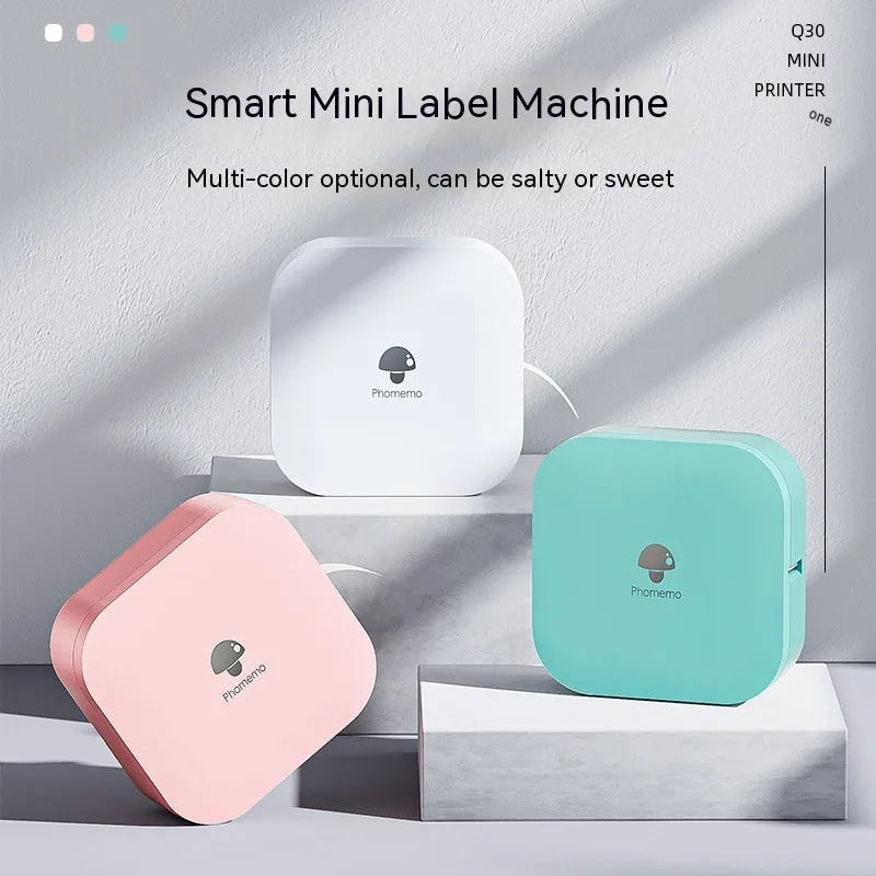 Q30 thermal mini label printer in green, compact size 82x82x32mm, with self-adhesive paper roll on white background