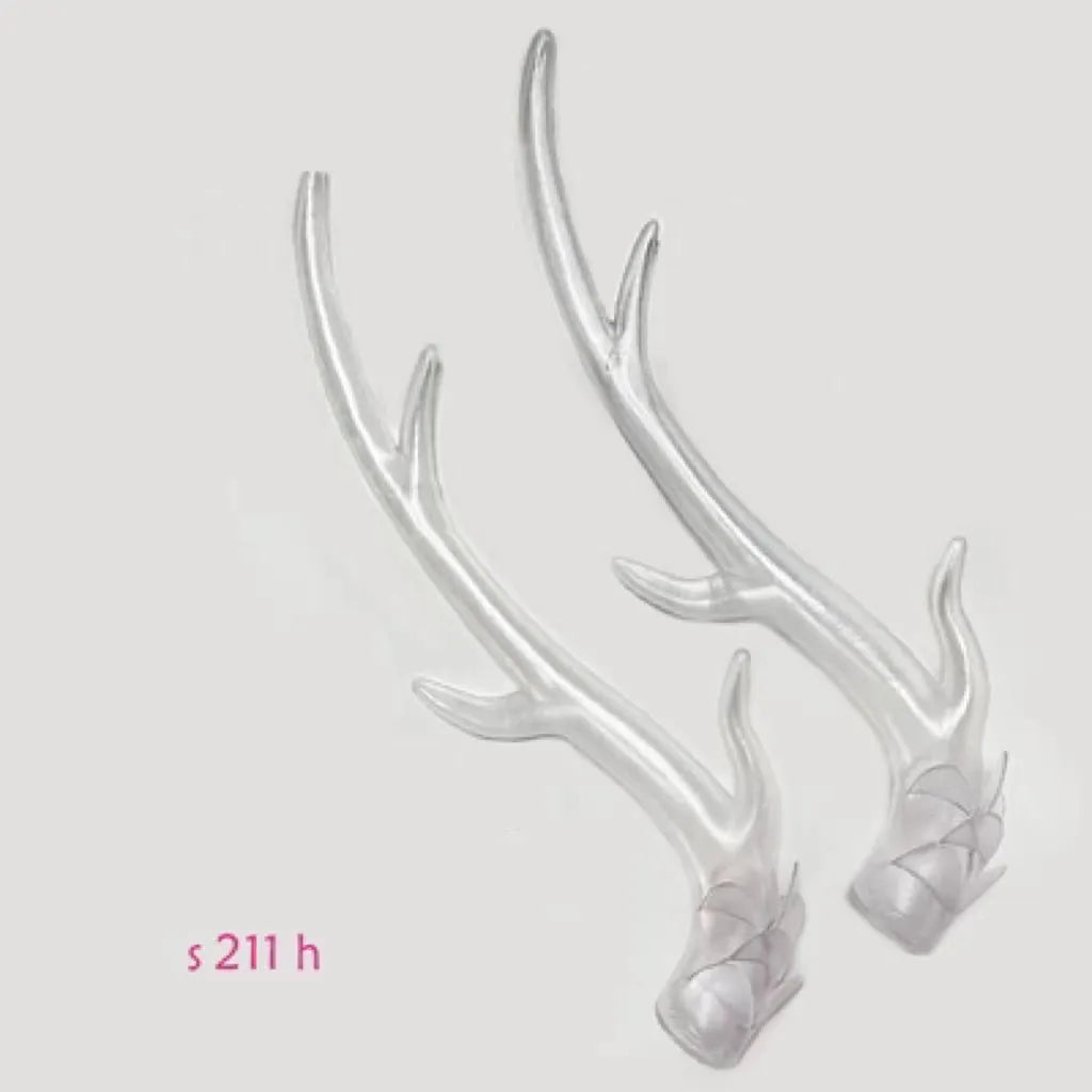 A pair of black resin dragon horn decorations for motorcycle helmet customisation, showing curved shape and mounting base.