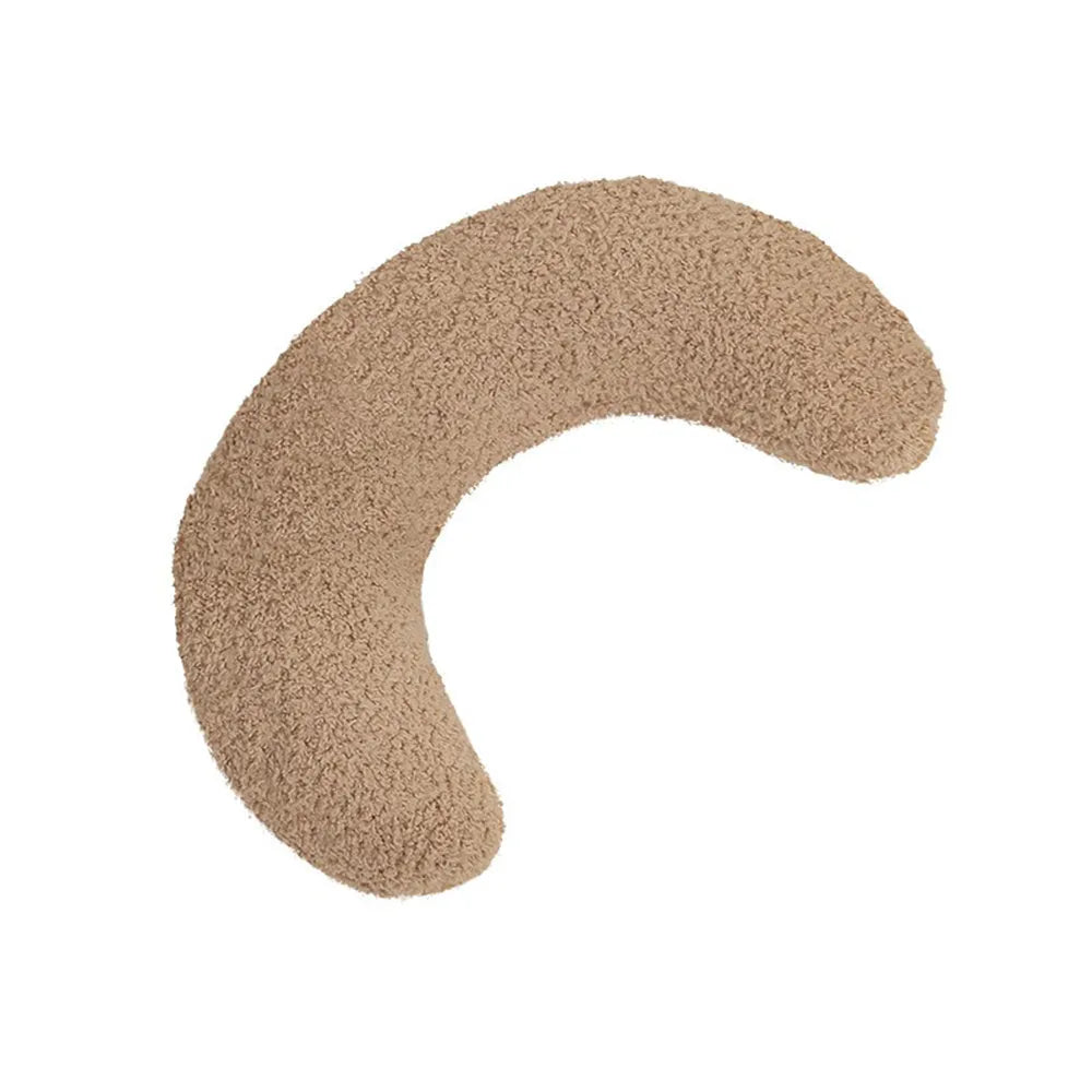 Blue U-shaped cat pillow with a white adjustable padded collar on a grey sofa.