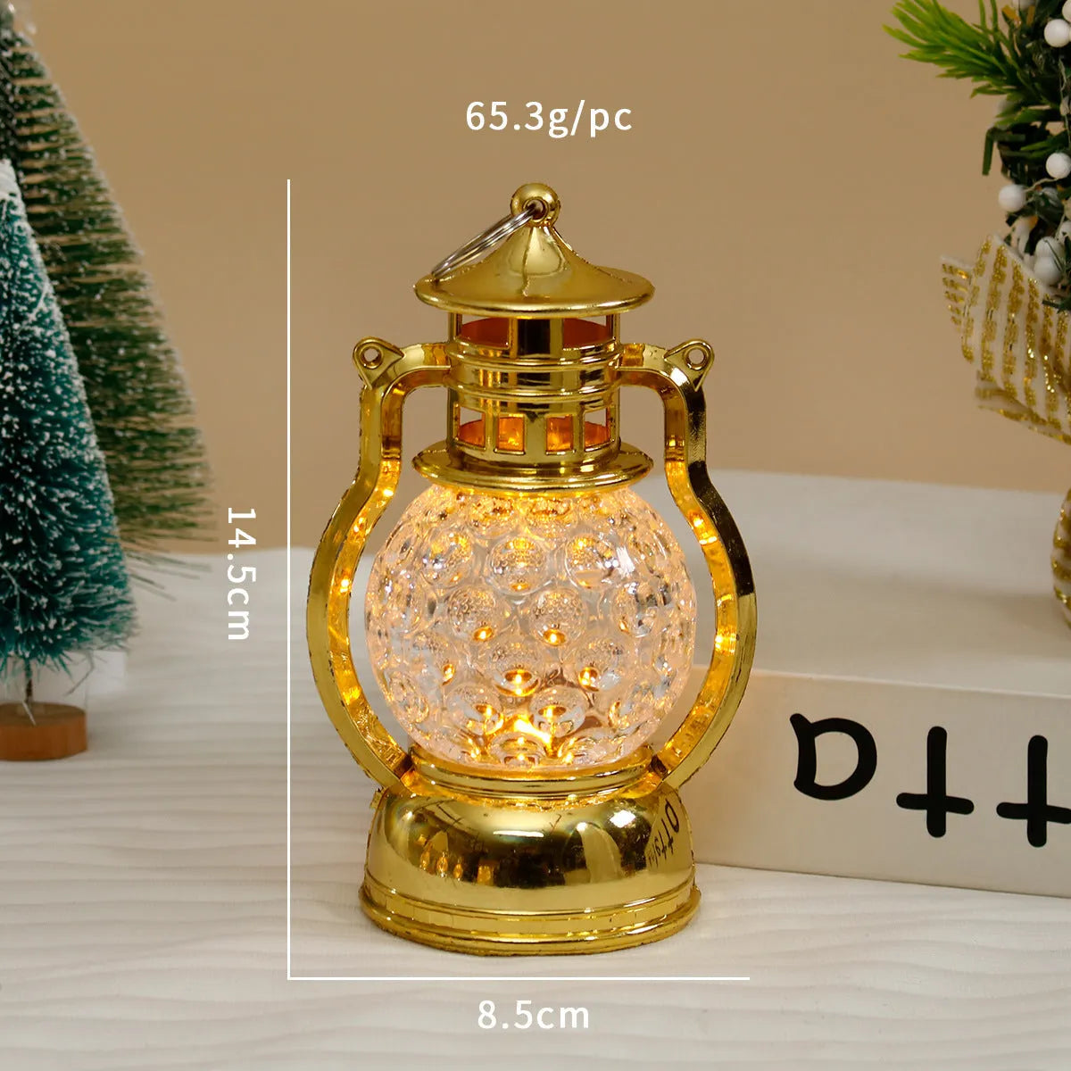 Small retro-style oil lamp LED night light in gold or silver finish on a table.