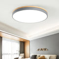 Round Nordic style ceiling lamp with solid wood and iron frame, white acrylic diffuser, shown in a living room setting.