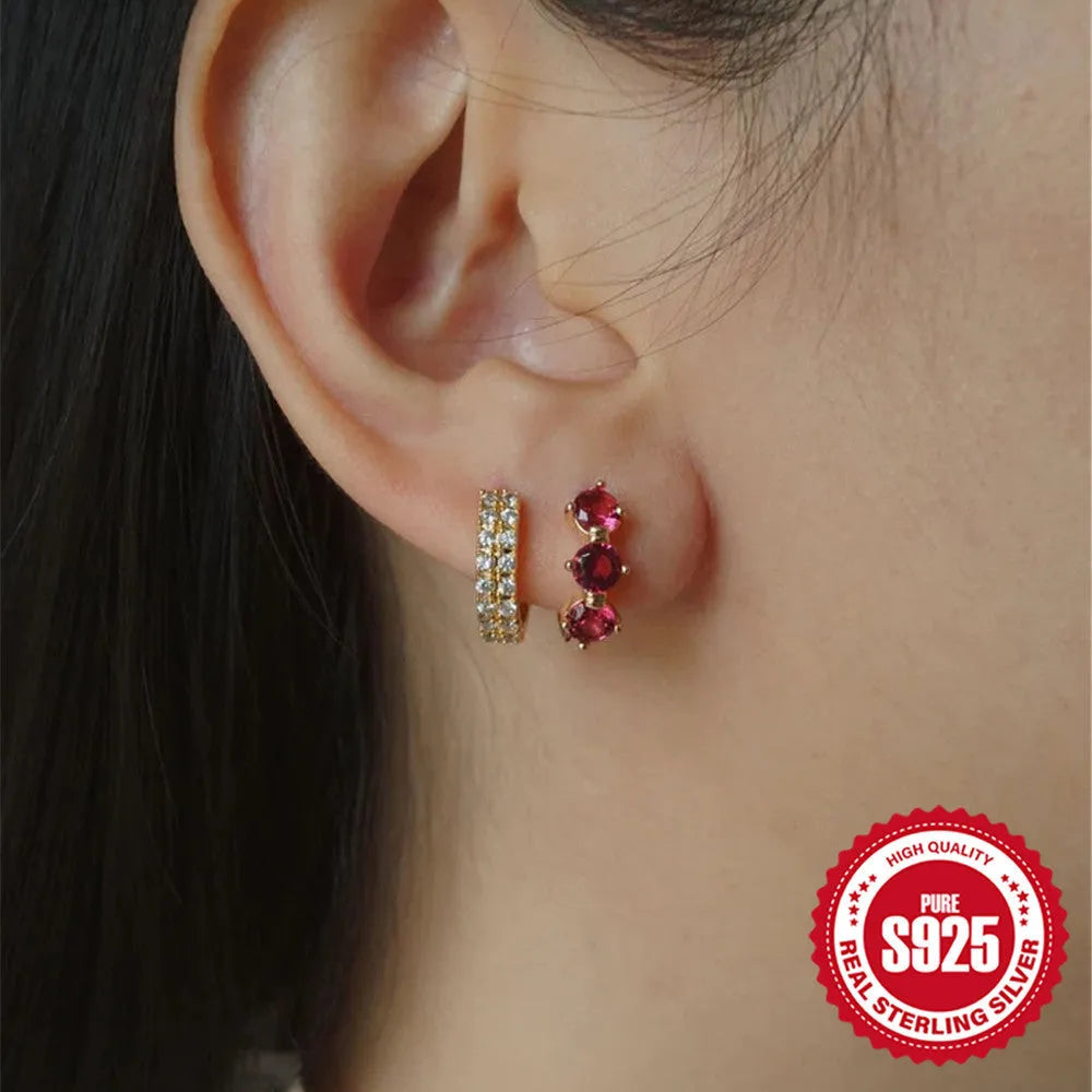 A pair of geometric sunflower design earrings in sterling silver with golden zircon stones.