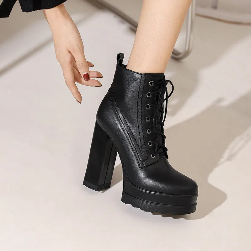 Women's black chunky heel waterproof platform boots with a side zipper on a cowhide upper.