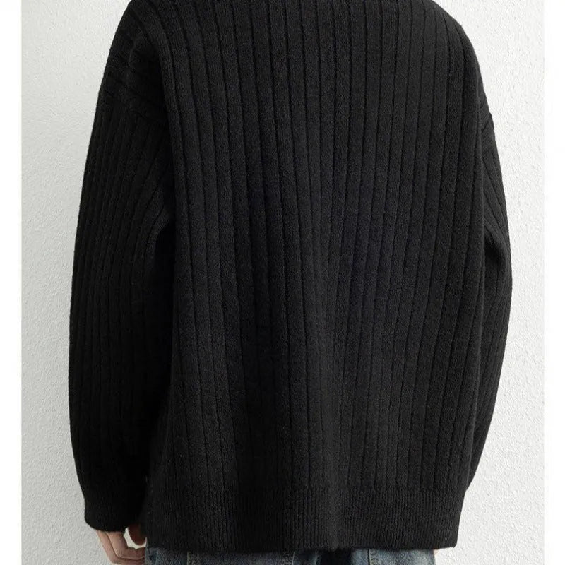 Men's loose grey half zip sweater with textured knit and long sleeves on a hanger.