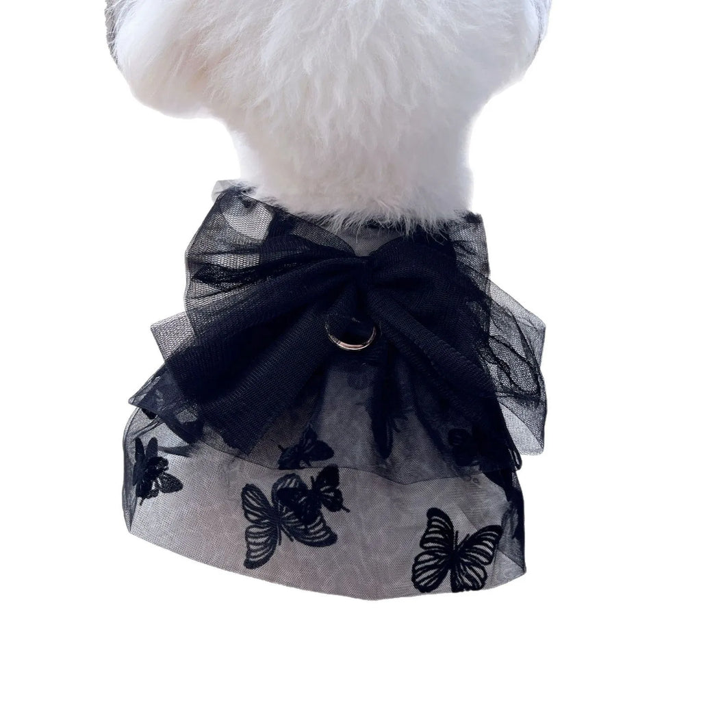 Black layered tulle princess skirt on a small dog, showing chest fit and full skirt silhouette.