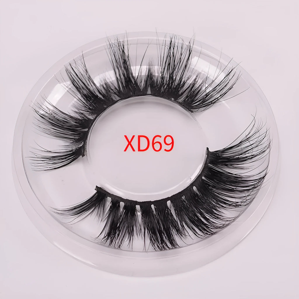 Hand-made 5D mink false eyelashes set with protective cap and dual-ended brush on a clean background