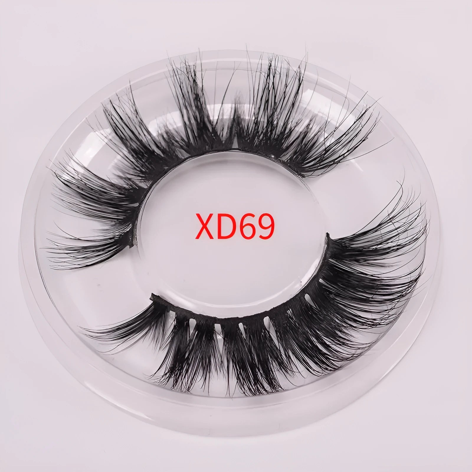 Hand-made 5D mink false eyelashes set with protective cap and dual-ended brush on a clean background