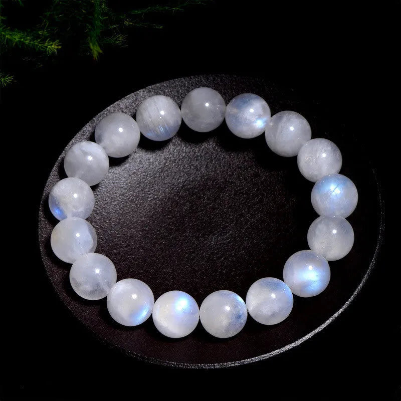 Natural blue moonlight round bead moonstone bracelet on a white background, showing polished geometric beads.