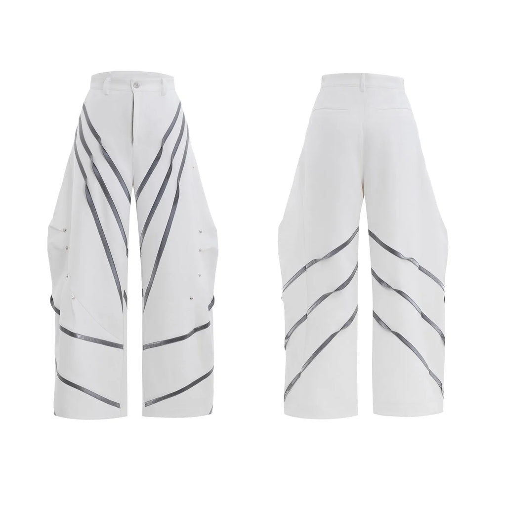 Men's black polyester trousers with three-dimensional cut and metal striped rivets on the pleats.