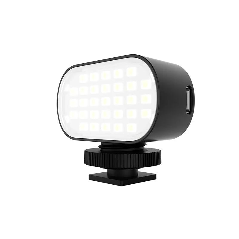 Black ST-30 mobile phone fill light with digital display, cold shoe mount, and included silicone diffuser.