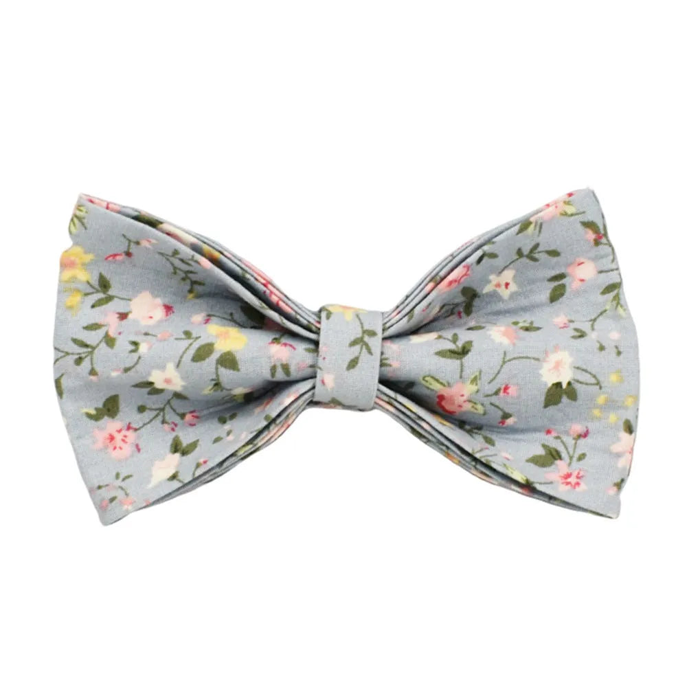 Floral print dog collar and leash set with matching bow, vest, and poop bag holder.