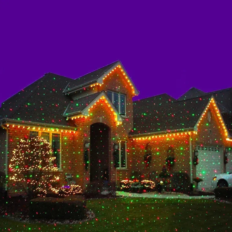 Christmas laser projector projecting red and green laser firefly patterns onto a garden tree at night, IP65 outdoor use