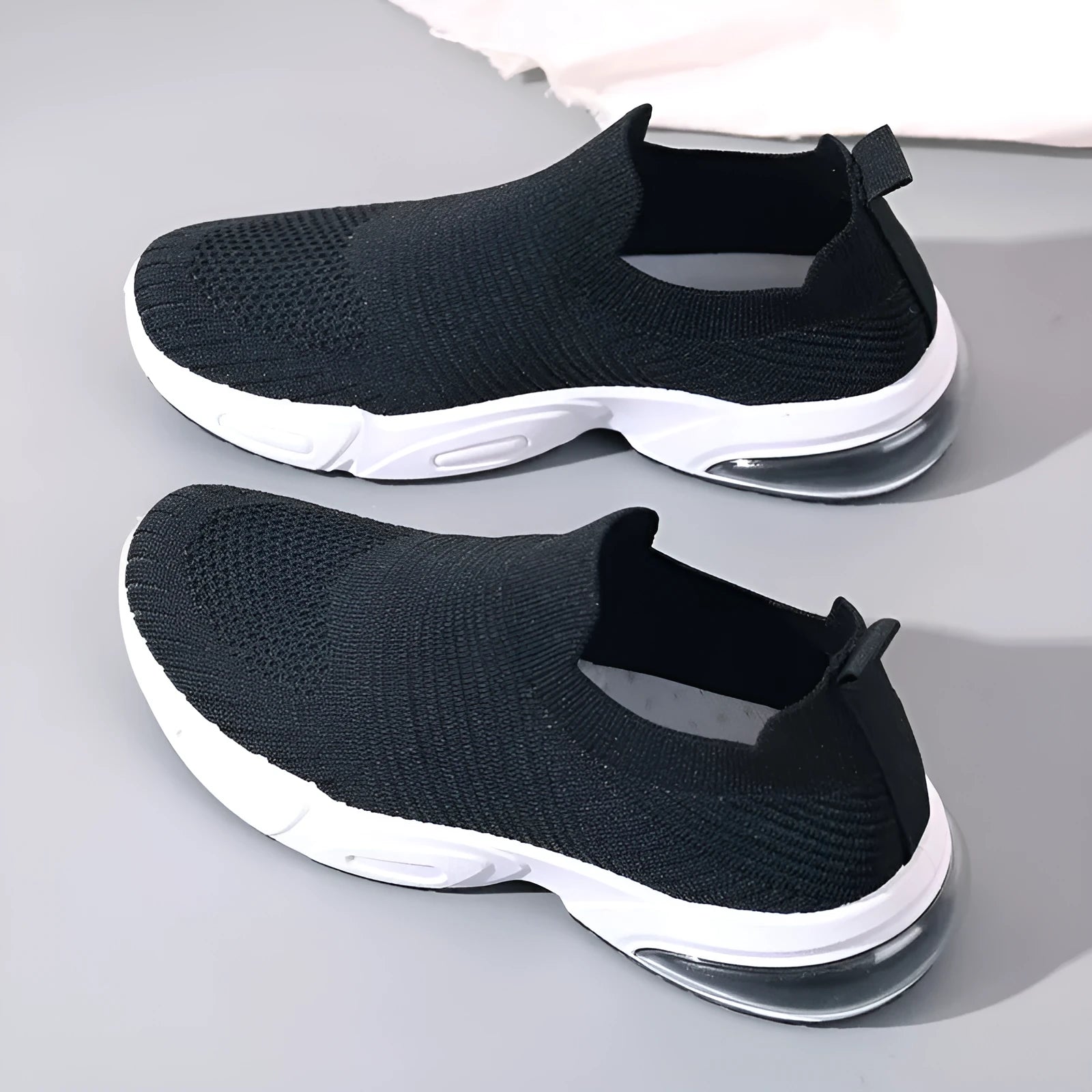 A pair of breathable mesh slip-on sock shoes with a PVC sole, shown in black colour.