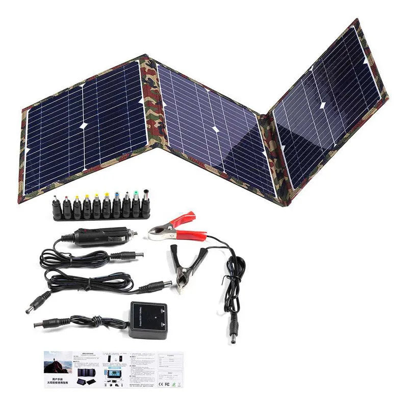 Black foldable 36W solar panel unfolded showing three monocrystalline silicon cells with charging accessories